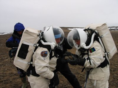 Vladimir Pletser and Katy Quinn examining a fossil found during EVA on Haynes Ridge.