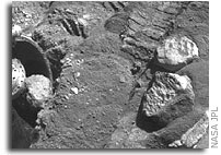 Potato-size Rock in Spirit's Wheel Well