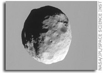 Janus Against Saturn's Clouds