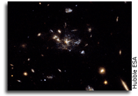 Spiderweb Galaxy Reveals Star-Forming Satellite Galaxies Merging
