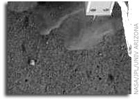NASA'S Phoenix Lander Robotic Arm Camera Sees Possible Ice