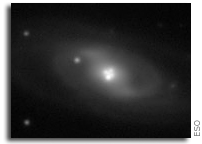 Astronomers Dissect a Supermassive Black Hole with Natural Magnifying Glasses