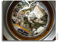 Photo: ISS Crew in Orlan Spacesuits inside Pirs  Docking Compartment