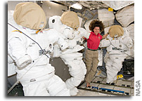 Image: Cady Coleman Hangs Out With Three Empty EVA Suits