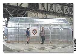 Keith Cowing and Marc Boucher stand in front of the greenhouse at the Second Astrobiology Science Conference.